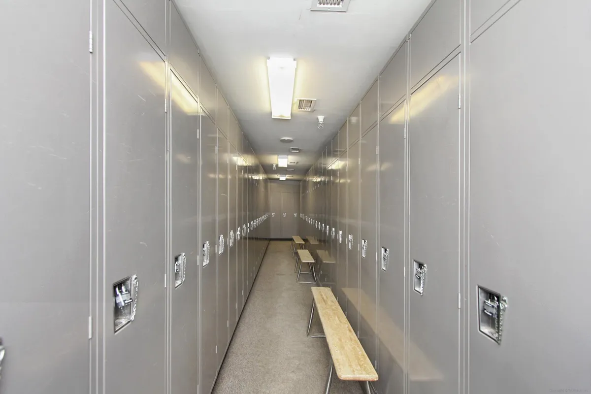 A functional interior space featuring metal lockers and wooden benches, designed for gear storage and preparation. The atmosphere is practical, supporting easy transitions from adventure to relaxation.